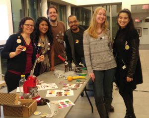 The protest pin event organizers pose around their creations