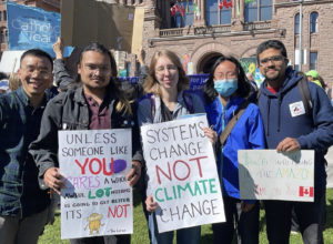 SCMers and friends at the Climate Strike in Toronto 2022, Sign reading Systems Change Not Climate Change